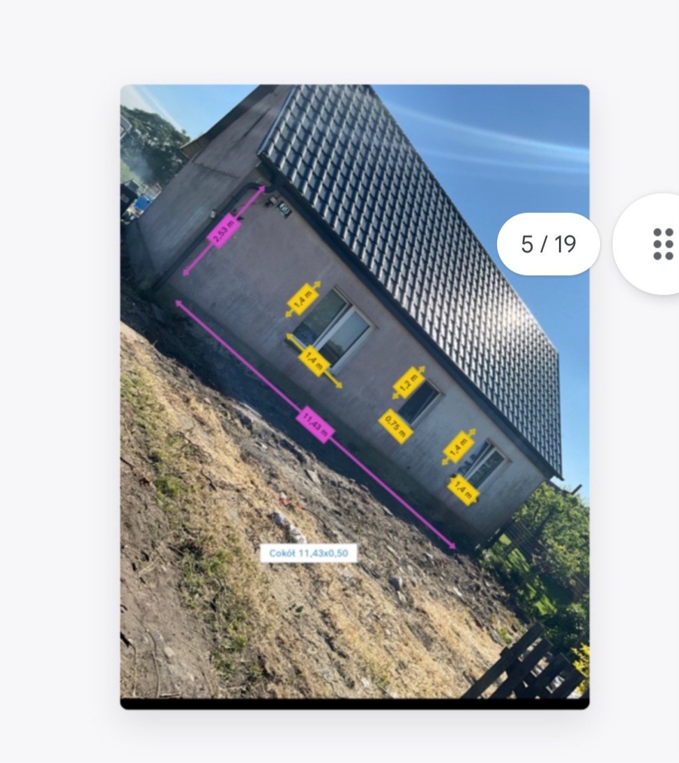 Skośny widok boczny budynku z zaznaczonymi wymiarami okien, ściany i cokołu na zewnątrz.