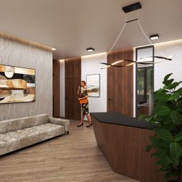 Infinito Design - Nowoczesne wnętrze biurowe z drewnianą ladą recepcyjną, sofą i abstrakcyjnym obrazem. Kobieta rozmawia przez telefon. Minimalistyczna lampa sufitowa.