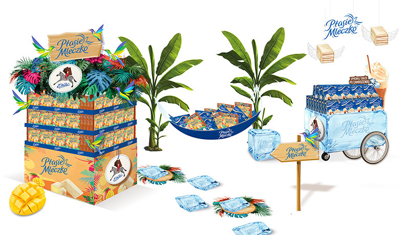 Tropikalna ekspozycja promocyjna słodyczy Ptasie Mleczko z motywami mango, palm, hamaka i wózka lodowego.