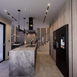 MAZZANI SPÓŁKA Z OGRANICZONĄ ODPOWIEDZIALNOŚCIĄ - Nowoczesna kuchnia z marmurową wyspą, czarną lodówką z ekranem dotykowym i oświetleniem LED. Widok na schody i salon w tle. Drewniane panele ścienne.