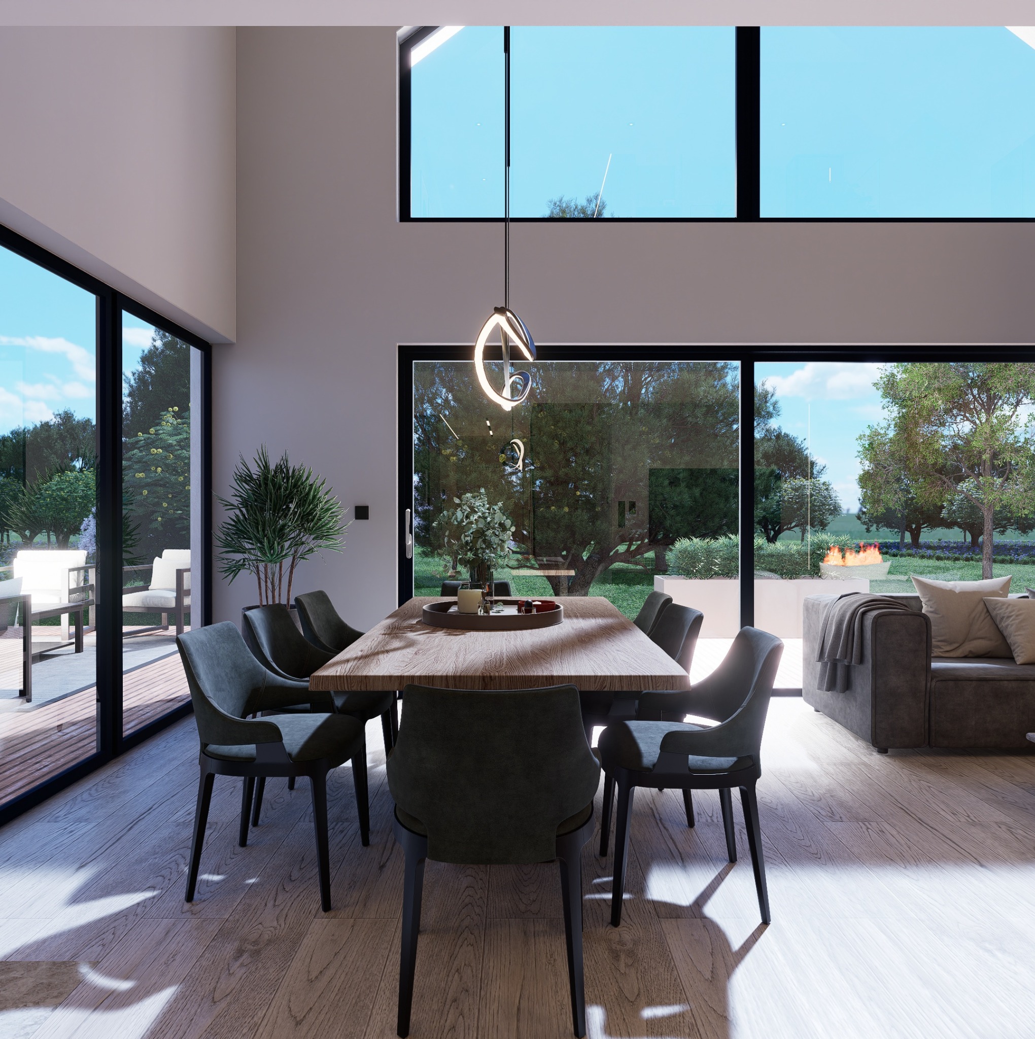 Jasne wnętrze jadalni z drewnianym stołem i szarymi krzesłami. Za oknami widok na zielony ogród z paleniskiem. Nowoczesna lampa wisząca nad stołem.