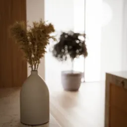 Minimalistyczne wnętrze: wazon z suszonymi trawami na marmurowym blacie, w tle rozmyta roślina doniczkowa i jasne okno.