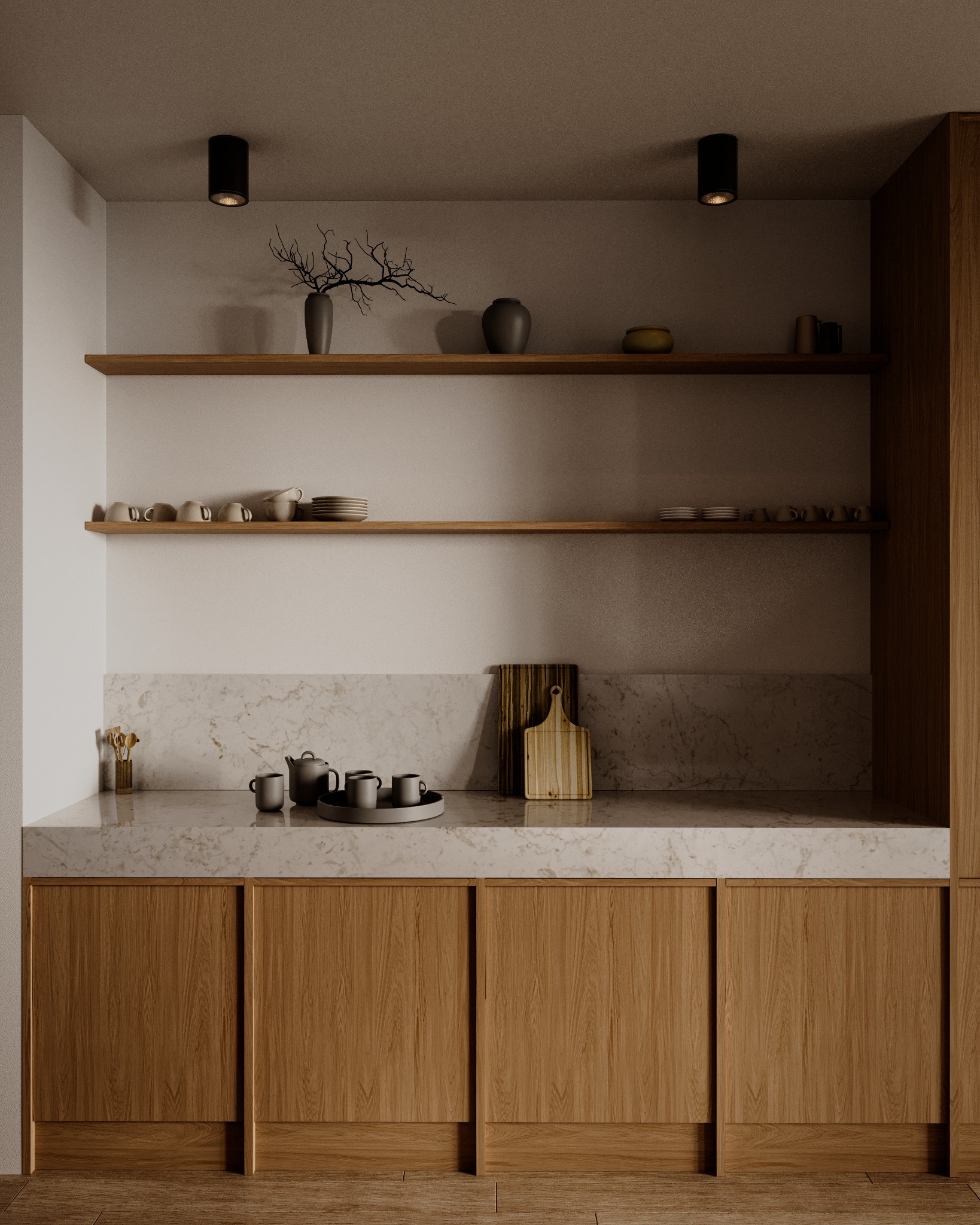 Minimalistyczna kuchnia z drewnianymi szafkami, marmurowym blatem i dekoracyjnymi elementami: wazony, gałązki i zestaw do herbaty na tacy.