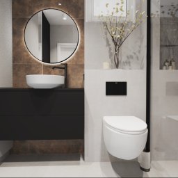 Joanna Marciniak - Nowoczesna łazienka z okrągłym lustrem podświetlanym LED, wiszącą miską WC i umywalką nablatową na czarnej szafce, całość w stonowanej kolorystyce z akcentami brązu.