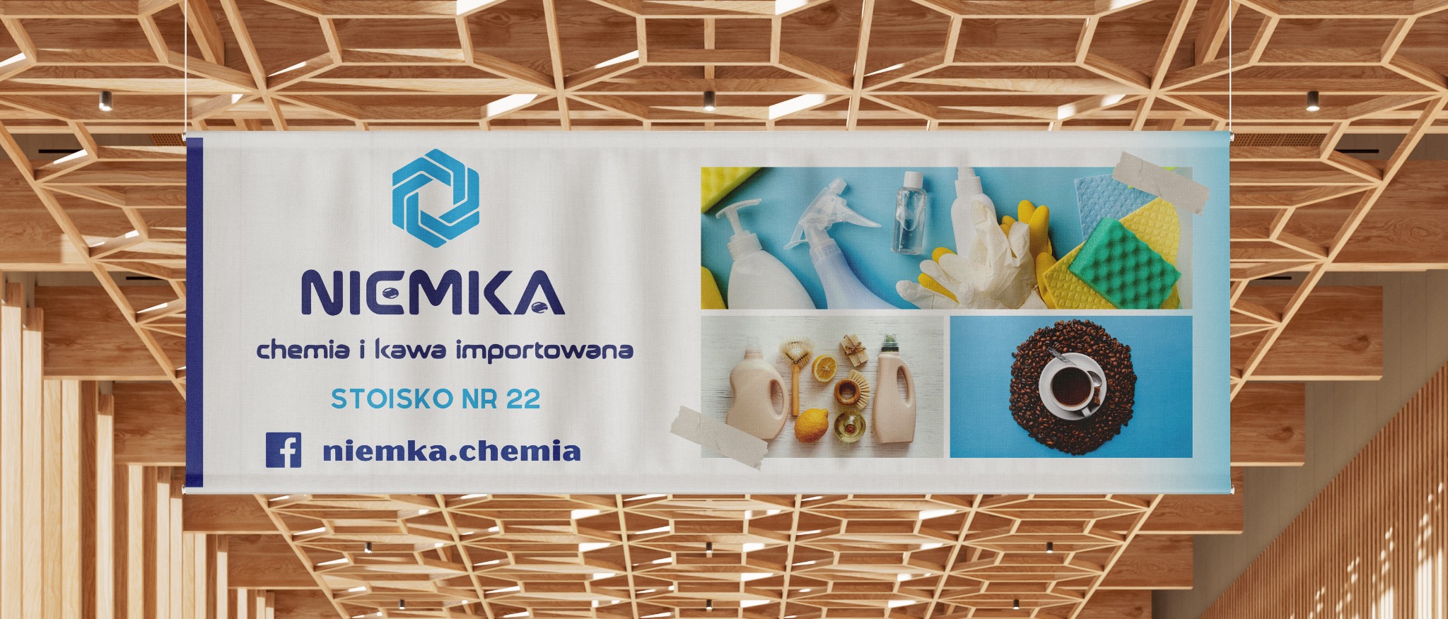 Baner reklamowy firmy Niemka z logo, informacją o chemii i kawie importowanej, numerem stoiska i adresem na Facebooku, wiszący pod drewnianym sufitem.