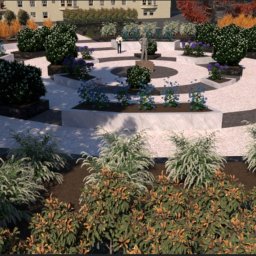 Adam Wypych - Projekt zagospodarowania terenu w Krakowie: wizualizacja okrągłego placu z rabatami kwiatowymi, krzewami i centralnie umieszczonym pomnikiem, otoczonego budynkami.