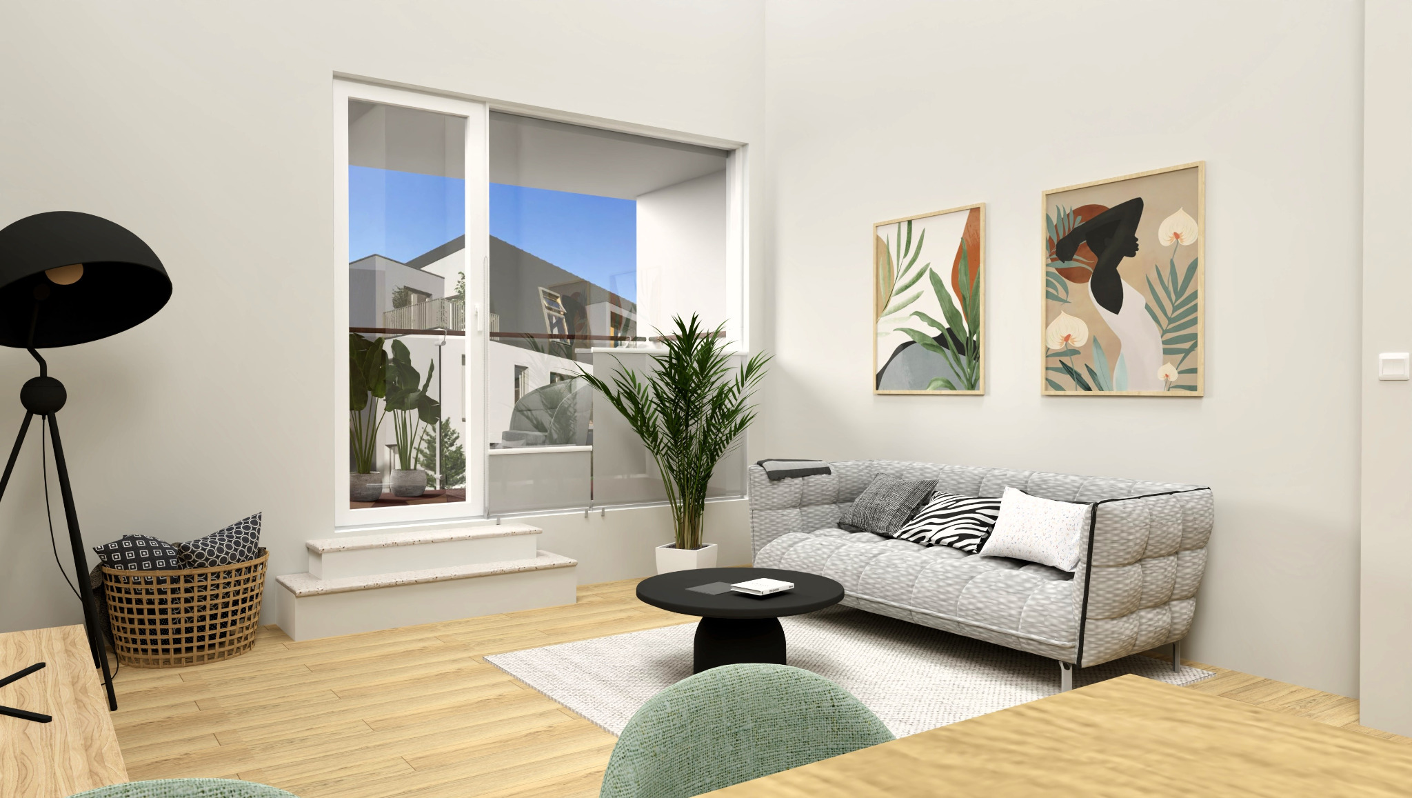 Jasne wnętrze salonu z szarą sofą modułową, okrągłym czarnym stolikiem kawowym, lampą na trójnogu i roślinami doniczkowymi, uzupełnione abstrakcyjnymi obrazami na ścianie i drewnianą podłogą.