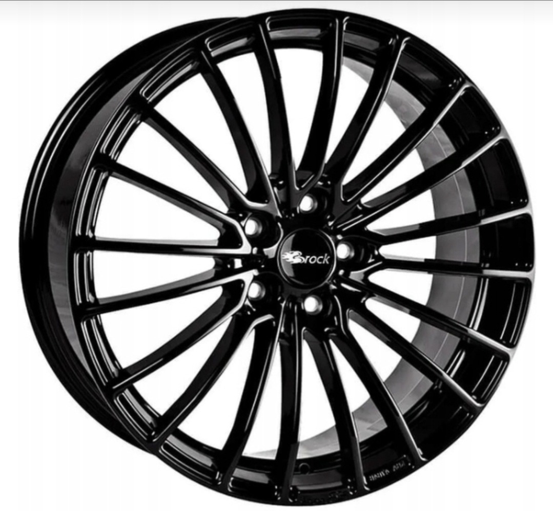 Błyszcząca, czarna felga aluminiowa marki Brock z wieloramiennym wzorem, widoczna na białym tle. Precyzyjne detale i głęboki połysk podkreślają nowoczesny design.