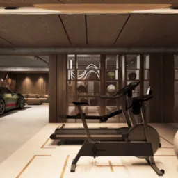 Nowoczesna aranżacja domowej siłowni z elementami garażu: sprzęt fitness, piłka do ćwiczeń i sportowe auta w tle, podkreślona ciepłym oświetleniem i drewnianym wykończeniem.