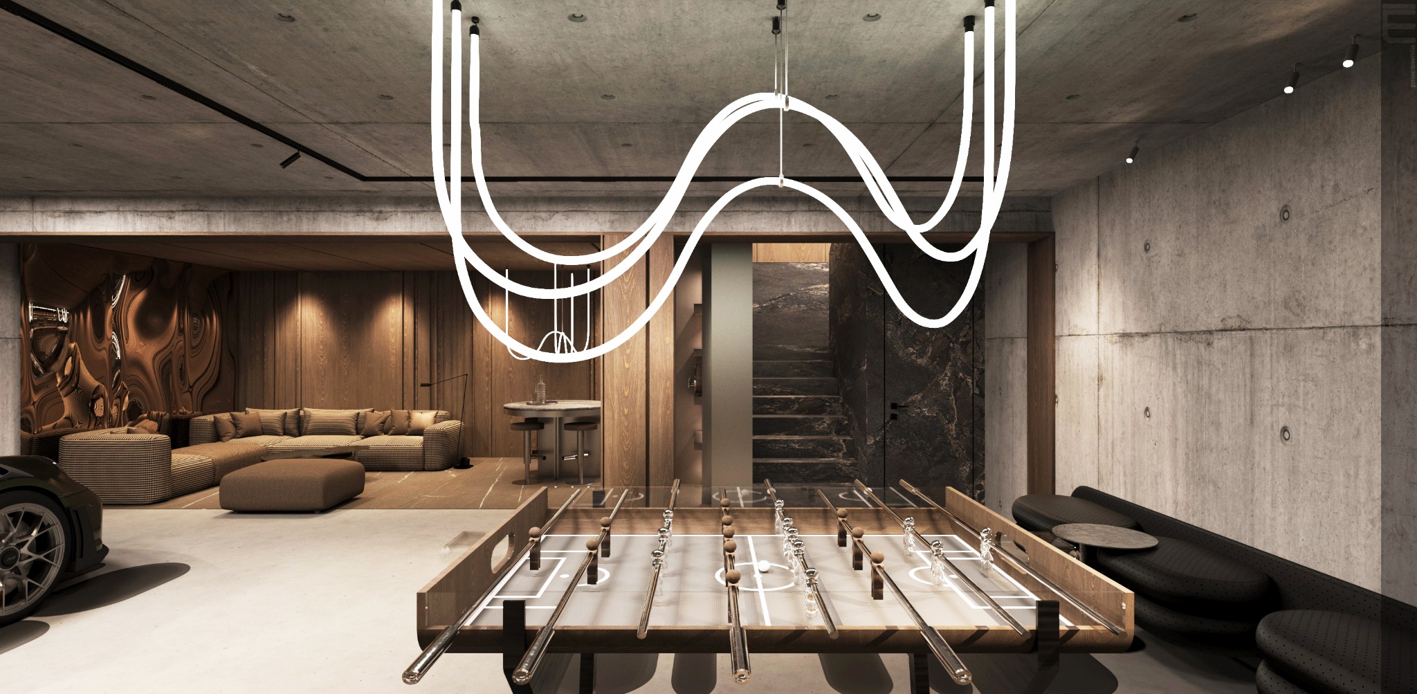 Nowoczesny salon z betonowymi ścianami, drewnianymi akcentami i unikalnym oświetleniem. Stół do piłkarzyków i częściowo widoczny sportowy samochód dodają charakteru.