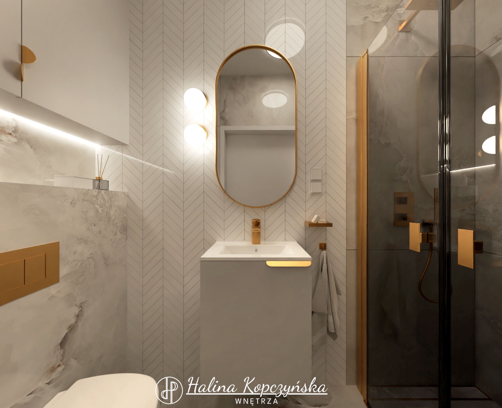 Nowoczesna łazienka z umywalką w kolorze szarym, owalnym lustrem w złotej ramie, armaturą w kolorze złota i kabiną prysznicową z elementami w kolorze złota, płytki na ścianach ułożone we wzór jodełki.