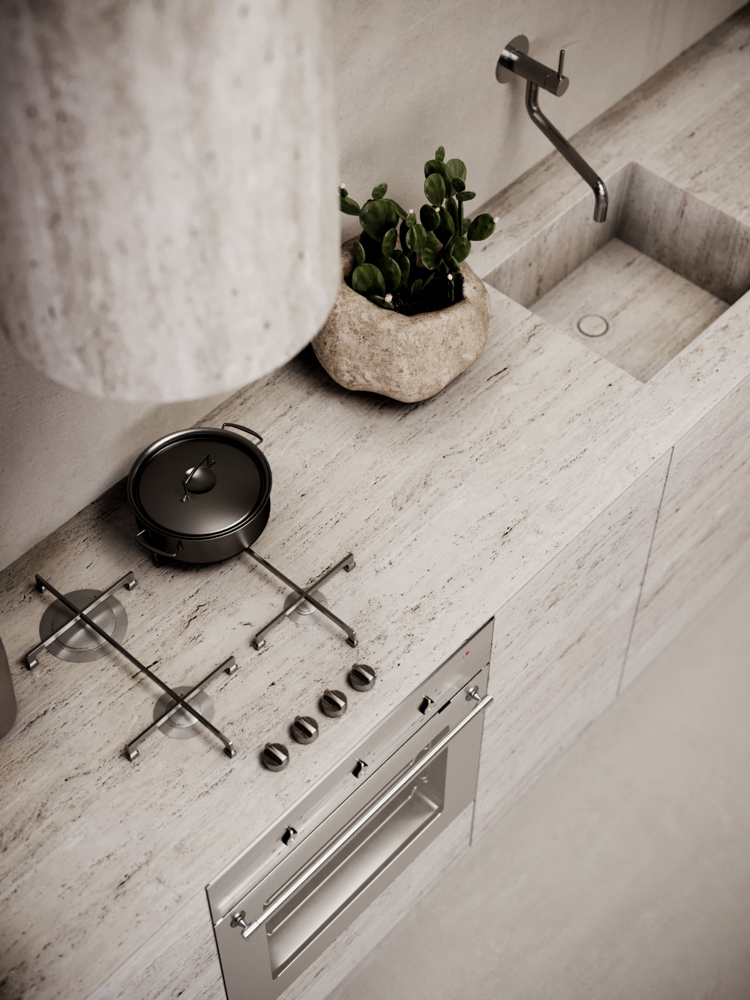 Minimalistyczna kuchnia z blatem i zlewem z trawertynu, płyta grzewcza z garnkiem, piekarnik ze stali nierdzewnej i doniczka z sukulentem.