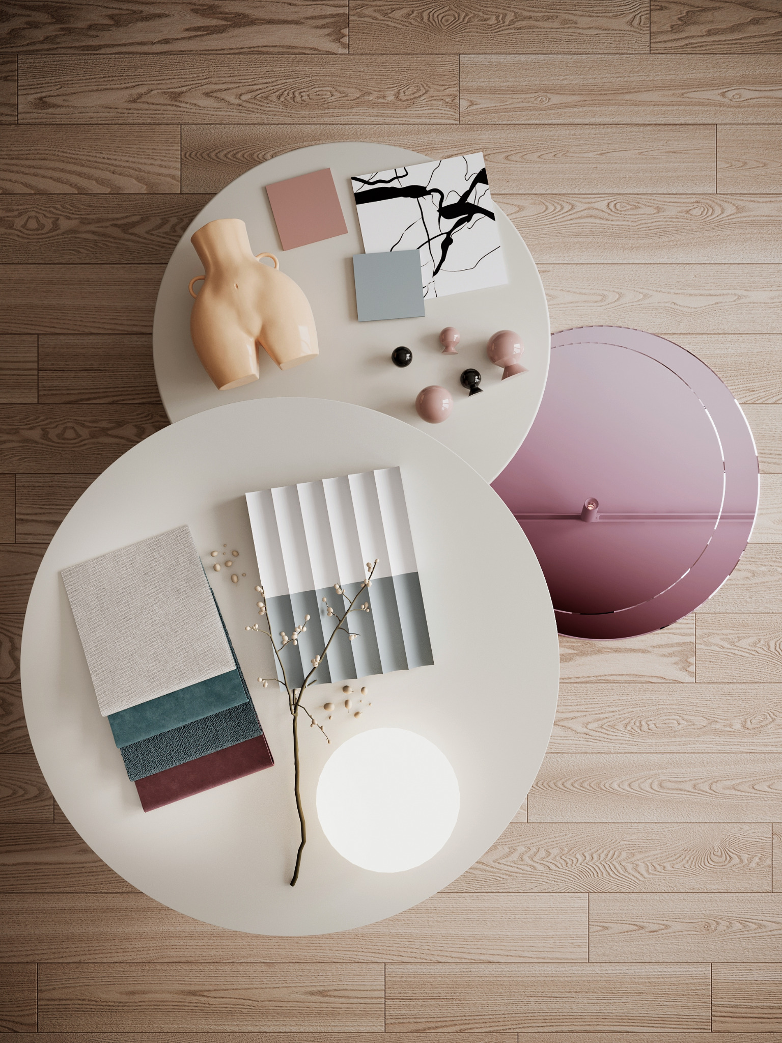 Moodboard z próbkami materiałów, kolorów i dekoracji na dwóch okrągłych stolikach na drewnianej podłodze we Wrocławiu. Widoczne próbki tkanin, kolorów farb, wazon w kształcie kobiecego ciała...