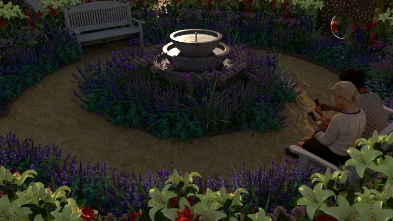 Fontanna w otoczeniu fioletowych kwiatów i ścieżki w ogrodzie. Dwie osoby siedzą na ławce, używając telefonów. W tle biała ławka i dekoracja z metalu.