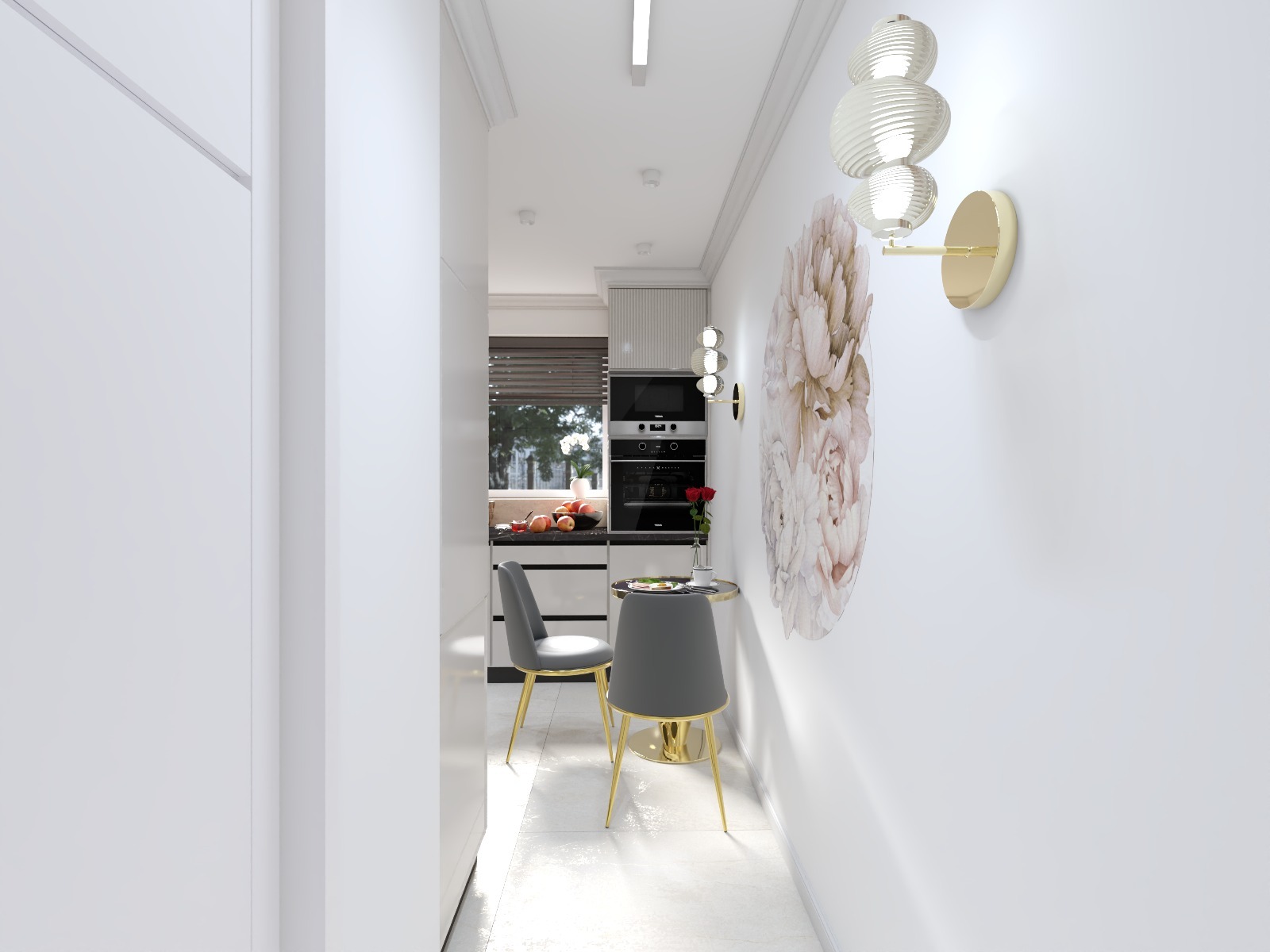 Wąska, jasna kuchnia z małym okrągłym stolikiem i dwoma krzesłami. Na ścianie dekoracja kwiatowa i nowoczesny kinkiet. Widok z korytarza.