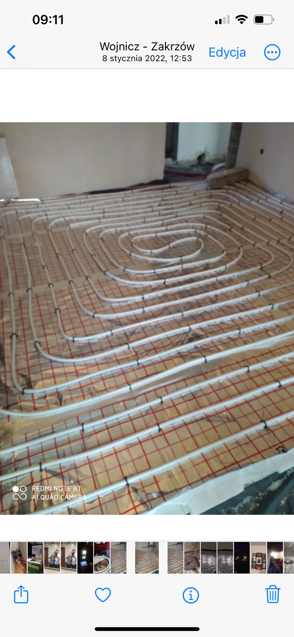 Rozłożone rury ogrzewania podłogowego na folii aluminiowej z czerwoną siatką, przed zalaniem wylewką, widok z góry.