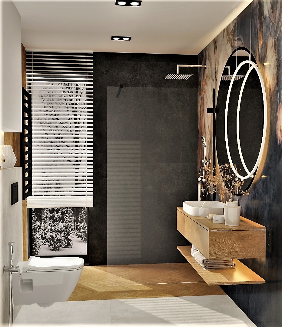 Nowoczesna łazienka z podwieszaną toaletą, kabiną prysznicową typu walk-in, umywalką nablatową i oświetlonym lustrem w kształcie elipsy na tle ściany z efektem marmuru, widok na zimowy krajobraz za...