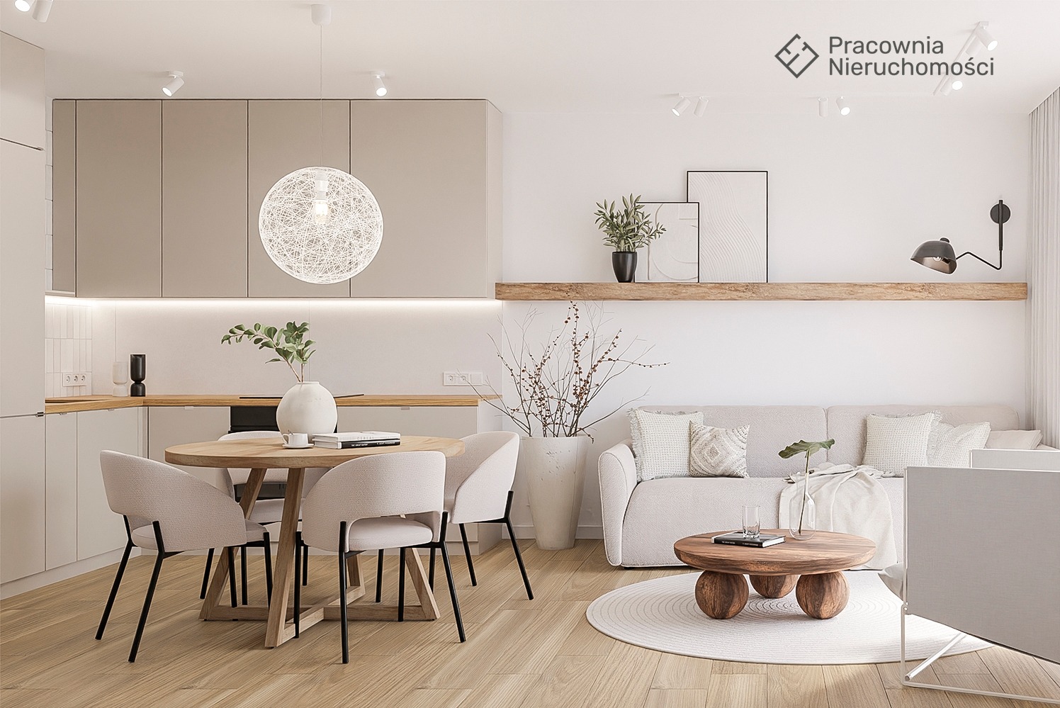 Jasne, przestronne wnętrze salonu z aneksem kuchennym, okrągły stół jadalny z krzesłami, sofa z poduszkami i okrągły stolik kawowy na dywanie, minimalistyczne dekoracje i oświetlenie.