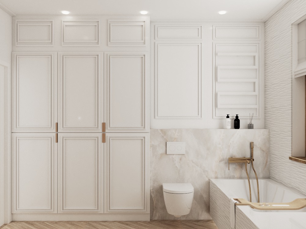 Elegancka łazienka w bieli: zabudowa meblowa z frezowanymi frontami, marmurowe wykończenie strefy umywalki i wanny, minimalistyczna armatura w odcieniach złota.