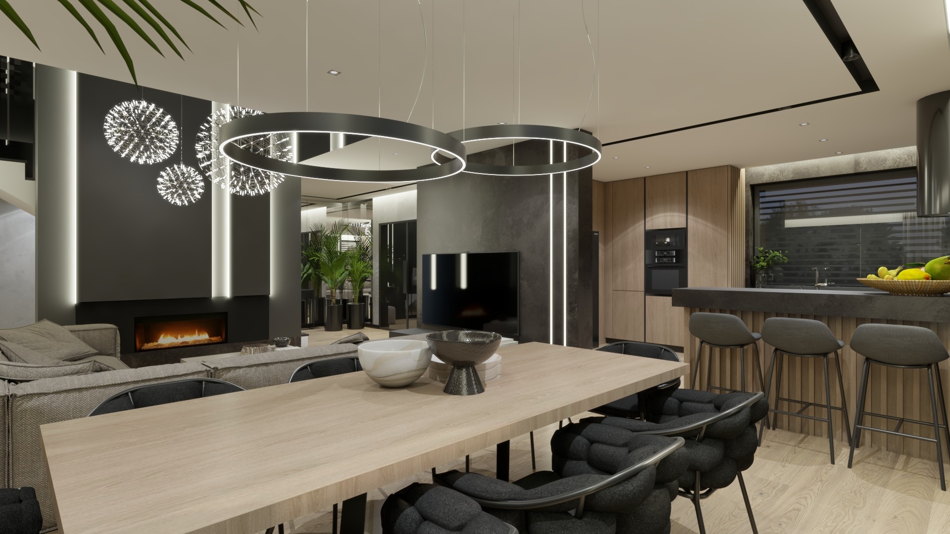 Nowoczesny salon z jadalnią i otwartą kuchnią, oświetlony wiszącymi lampami w kształcie pierścieni i kul, z kominkiem w czarnej ścianie i drewnianymi akcentami.