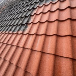 SZERSZEŃ Dawid Leśniowski - Częściowo oczyszczony dach z czerwonej dachówki, widoczna różnica między brudną, czarną powierzchnią a czystą, czerwoną po prawej stronie.