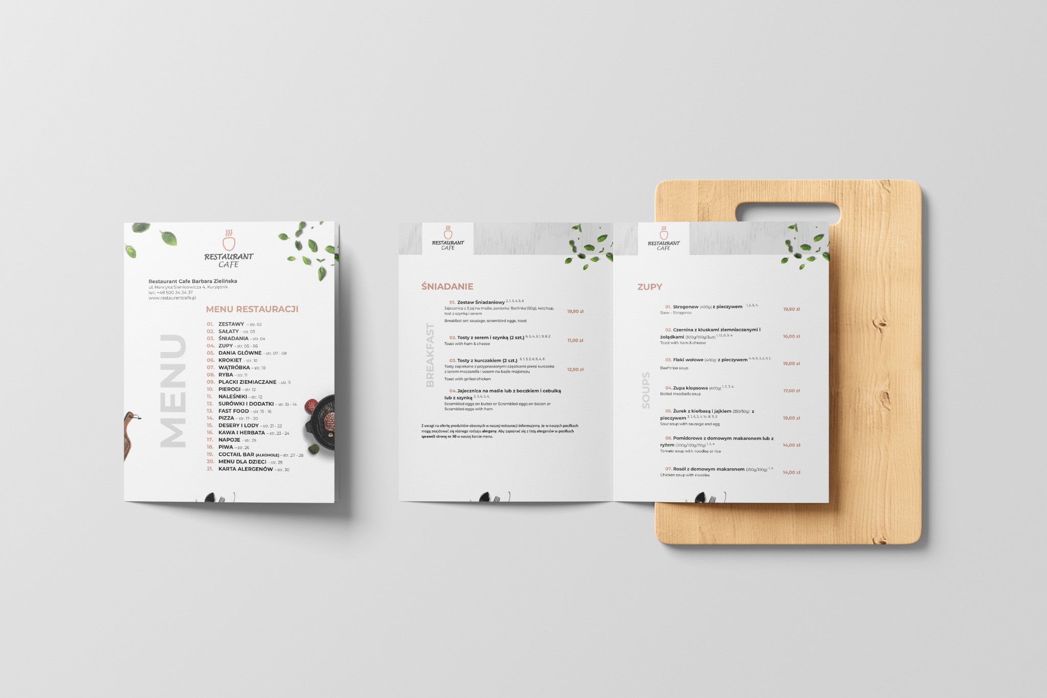 Trzy menu restauracji Cafe Barbara Zielińska, pokazujące ofertę śniadaniową i zup, ułożone na białym tle i drewnianej desce.