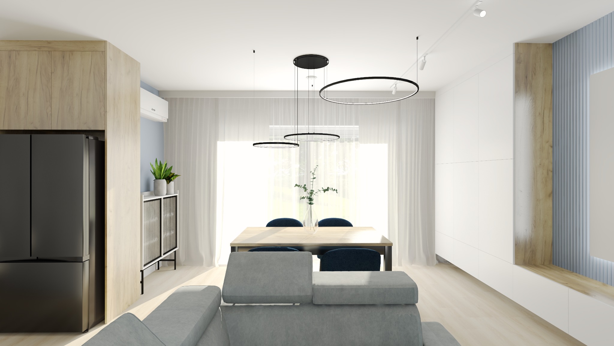 Jasne wnętrze z drewnianymi akcentami: stół z krzesłami, sofa i nowoczesne oświetlenie w postaci okrągłych lamp wiszących. Widok na okno z delikatnymi zasłonami.