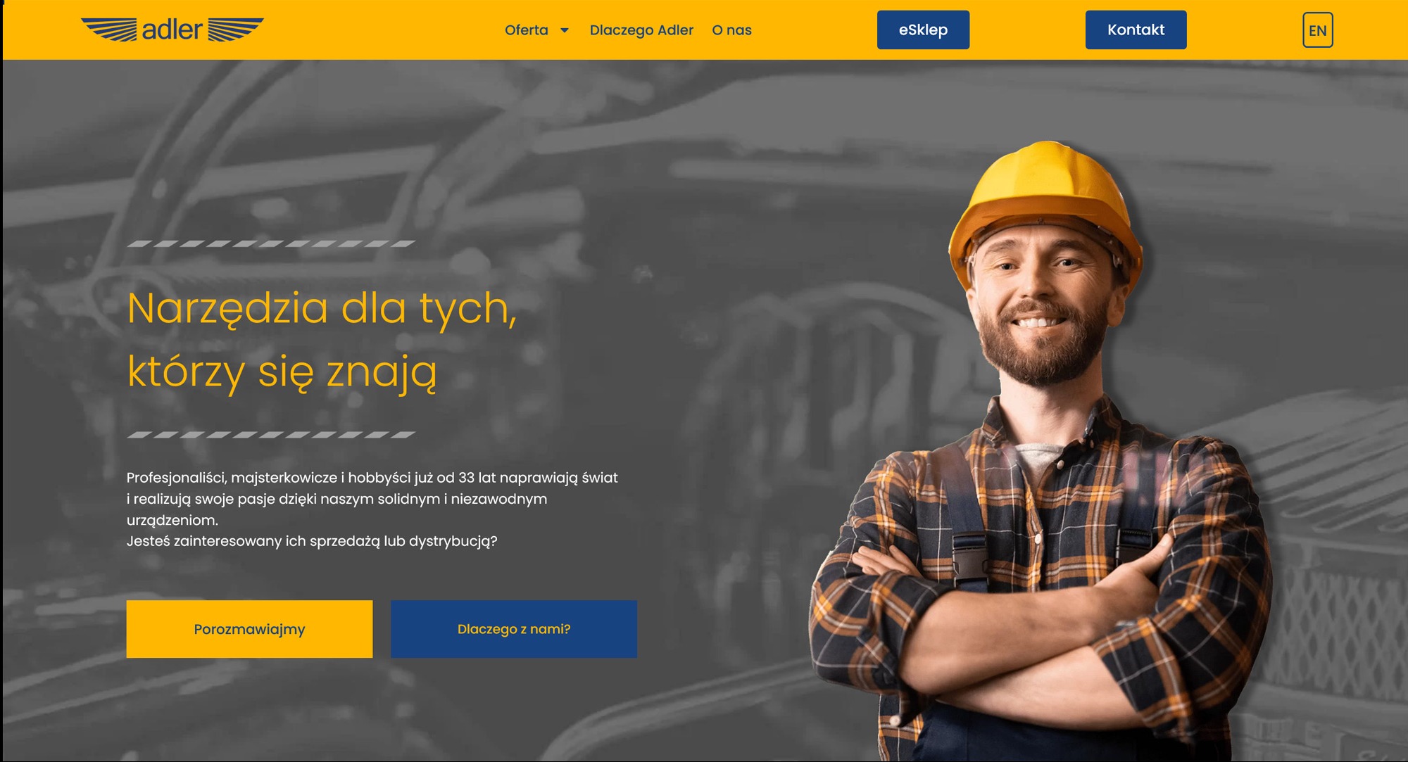Strona internetowa producenta narzędzi Adler, prezentująca uśmiechniętego mężczyznę w kasku i roboczym ubraniu na tle grafiki z narzędziami.