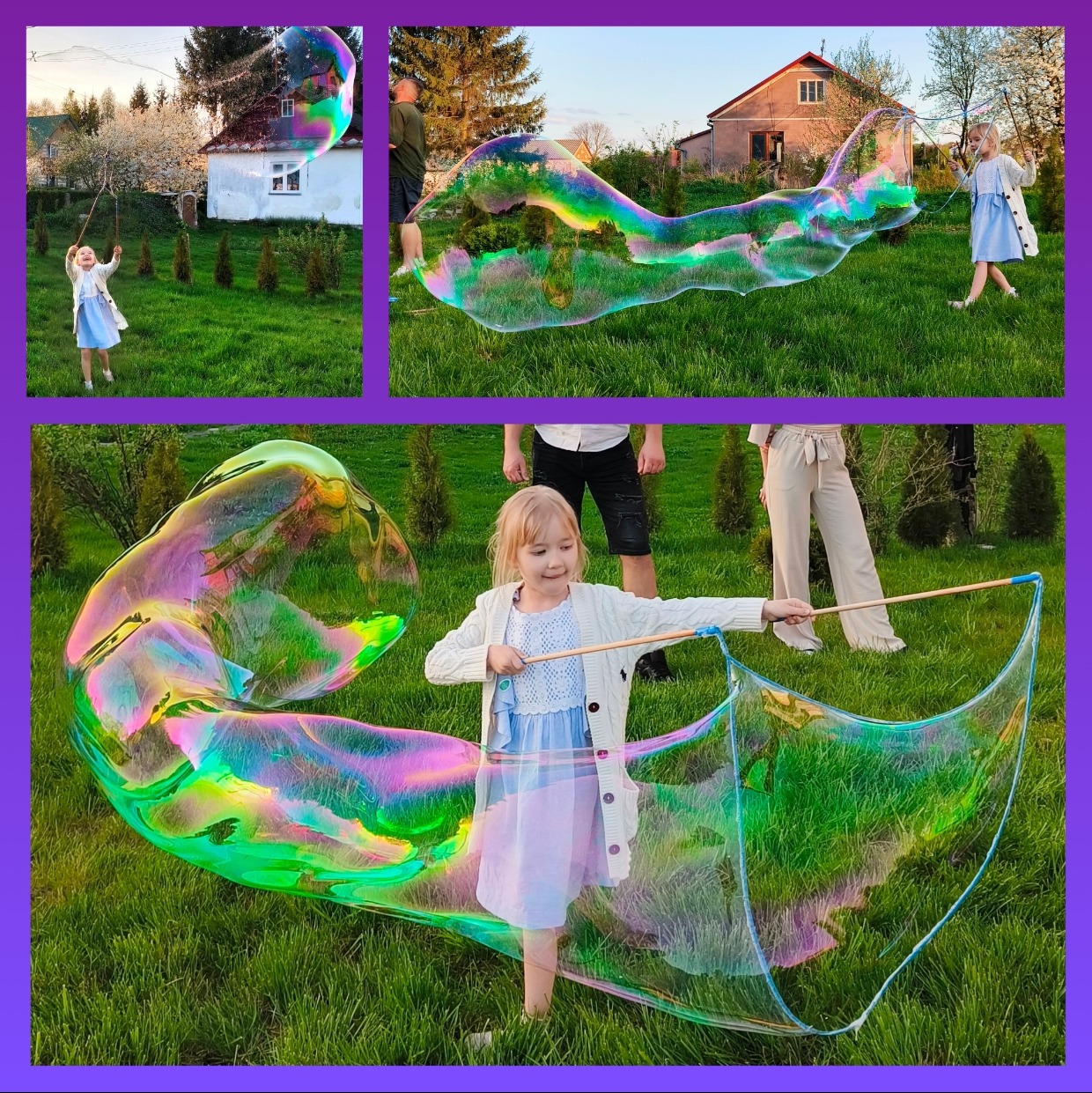 Dziewczynka w niebieskiej sukience puszcza ogromne tęczowe bańki mydlane za pomocą specjalnego sznurka na trawniku przed domem.