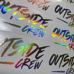 MTDesign Michał Tarnaski - Arkusz z naklejkami 'Outside Crew' z efektem holograficznym w różnych kolorach, ułożone rzędami na białym tle.