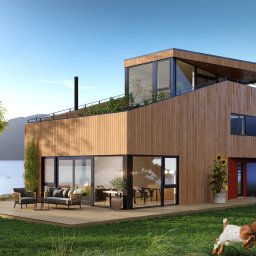 HAUKON Sp z.o.o firma budowlana - Nowoczesny dom z drewnianą elewacją i tarasem, widok na jezioro i góry, owce i koza na pierwszym planie, roślinność na dachu.