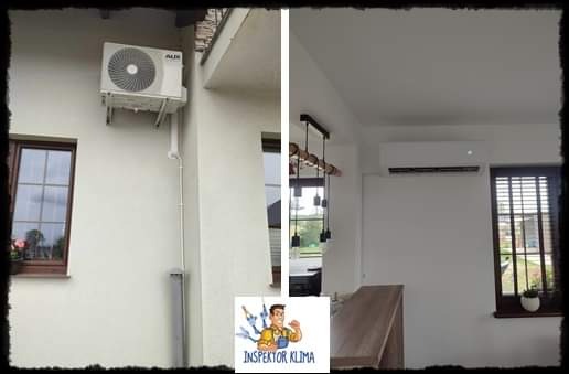 Zewnętrzna i wewnętrzna jednostka klimatyzacji AUX zamontowana na ścianie budynku jednorodzinnego, widoczne rury odprowadzające skropliny. W tle okno z kwiatami.