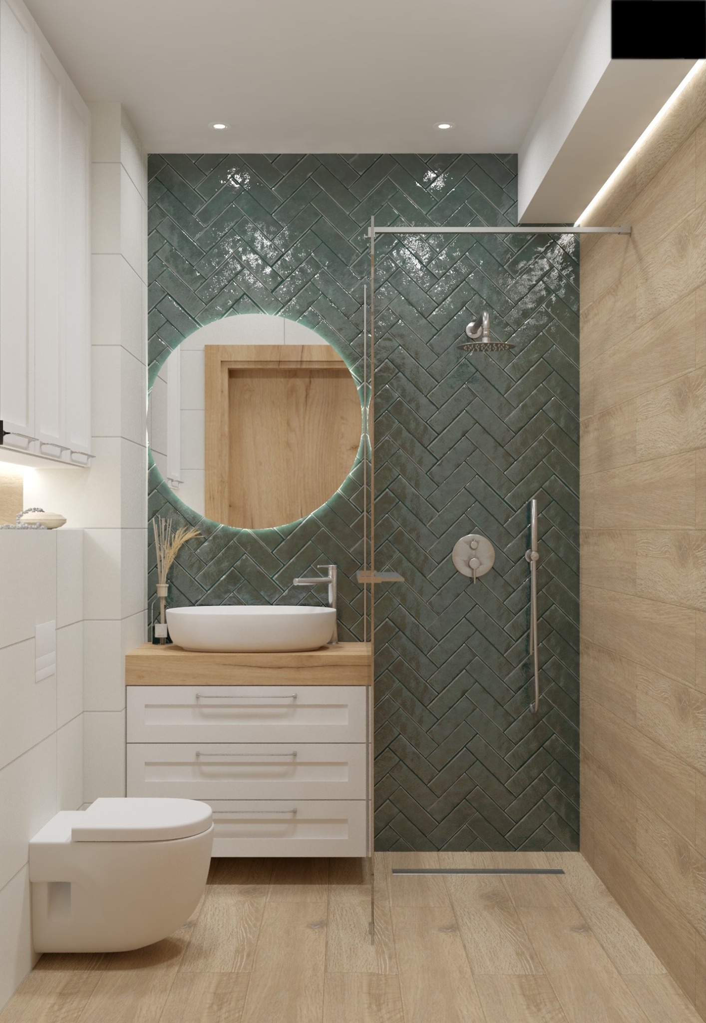 Nowoczesna łazienka z zielonymi płytkami ułożonymi w jodełkę, okrągłym lustrem z podświetleniem LED, umywalką nablatową na drewnianym blacie i podwieszaną toaletą.