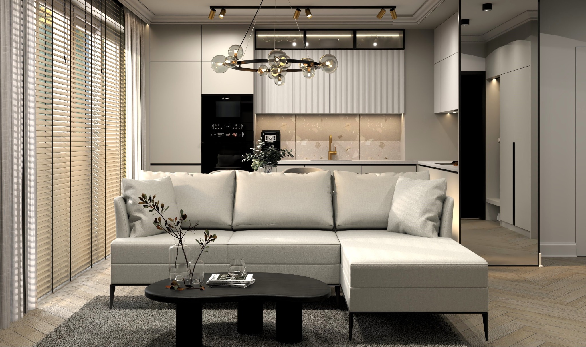 Nowoczesne wnętrze w Krakowie: jasny salon z narożnikiem i minimalistyczną kuchnią w tle, oświetlone designerską lampą wiszącą i światłem z okna z żaluzjami.