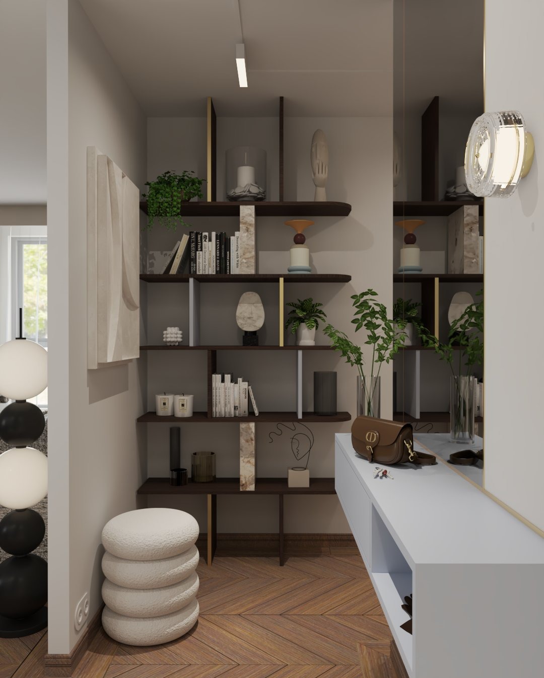 Stylowy przedpokój z drewnianą podłogą w jodełkę. Na ścianie półki z dekoracjami, obok lustro i pufa. Minimalistyczny design, ciepłe oświetlenie.