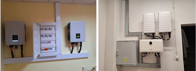 Instalacja fotowoltaiczna wewnątrz budynku: widok na rozdzielnicę elektryczną z otwartymi drzwiczkami, falownik z zieloną diodą i przewody, oraz drugi zestaw urządzeń na sąsiedniej ścianie,...