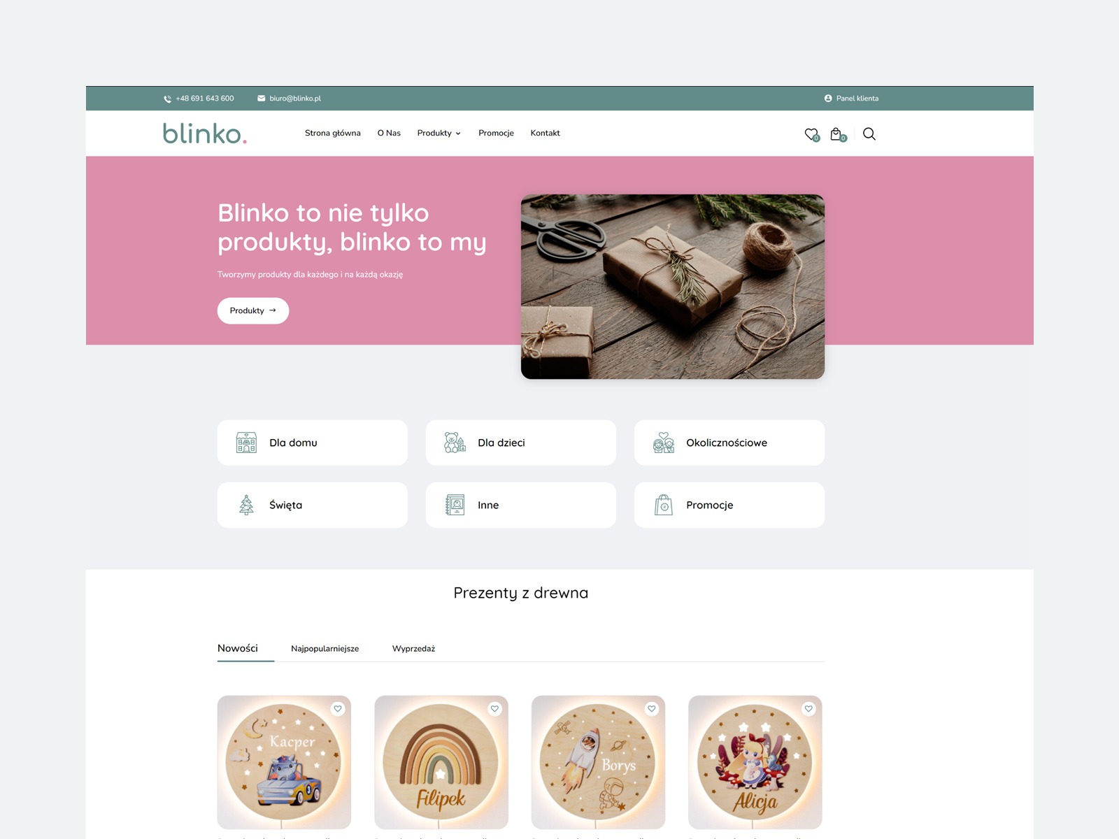 Projekt strony internetowej sklepu z prezentami, widoczne elementy nawigacyjne, grafika z zapakowanymi prezentami i drewniane lampki z imionami dzieci.
