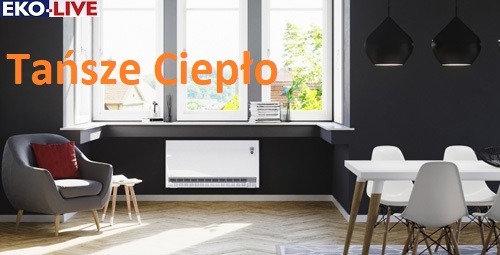 Eleganckie wnętrze z grzejnikiem elektrycznym pod oknem, szary fotel z czerwoną poduszką, biały stół z krzesłami, czarne lampy wiszące, parkiet na podłodze.