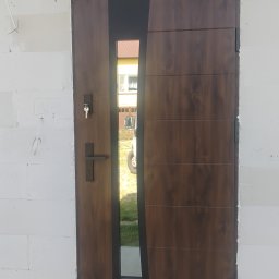 Drzwi drewnopodobne, montaż drzwi zewnętrznych z doświetleniem. Precyzyjne osadzenie to gwarancja ciepłego domu