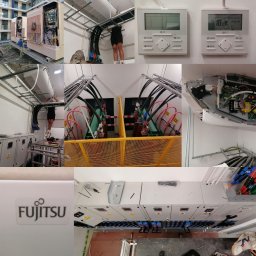 DAMIAN MILCZEK DM-AQUA USŁUGI INSTALACYJNE I WENTYLACJA - Instalacja przemysłowej klimatyzacji: Agregaty chłodnicze na dachu budynku, kable w korytach, sterowniki ścienne, szafy elektryczne z oznaczeniami, widoczny pracownik na drabinie montujący...