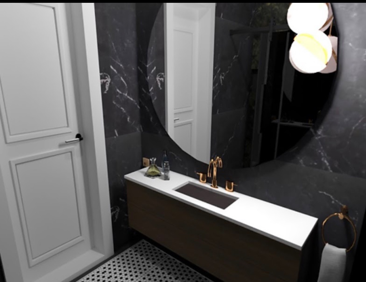 Wizualizacja łazienki z umywalką nablatową, złotą armaturą i okrągłym lustrem na tle marmurowej ściany, widoczna butelka perfum i dozownik mydła.