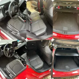 Wnętrze czerwonej Toyoty Corolla kombi: przednie i tylne siedzenia z czarną tapicerką z czerwonymi i białymi akcentami, deska rozdzielcza z ekranem dotykowym, oraz bagażnik z roletą, ukazujące stan...