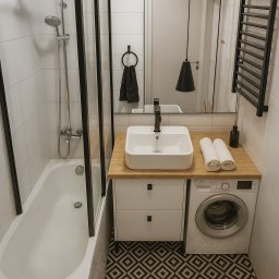 Vanita Design Justyna Kasprzycka - Nowoczesna łazienka w bieli i czerni: wanna z parawanem, umywalka nablatowa, pralka pod blatem, geometryczna podłoga. Minimalistyczny design z akcentami drewna.