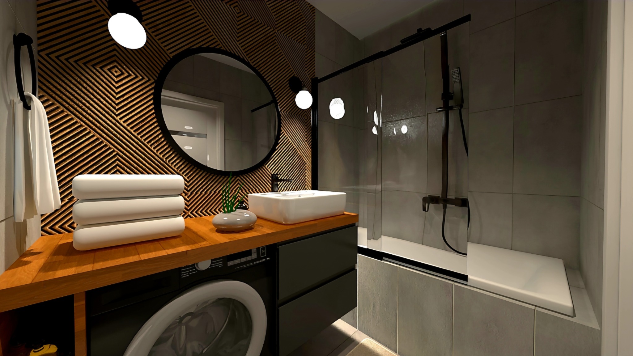 Nowoczesna łazienka z drewnianą ścianą, okrągłym lustrem, białą umywalką nablatową, pralką pod blatem i kabiną prysznicową ze szklanymi drzwiami.