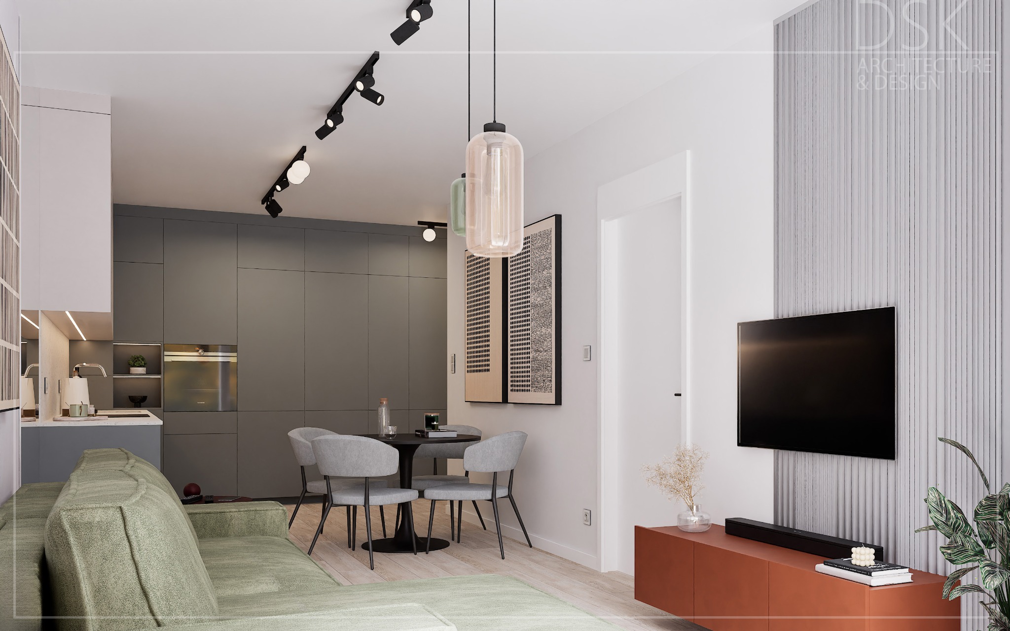 Nowoczesne wnętrze mieszkania: szara zabudowa kuchenna, okrągły stół z krzesłami, zielona sofa, telewizor na ścianie z dekoracyjnymi panelami. Minimalistyczny design.