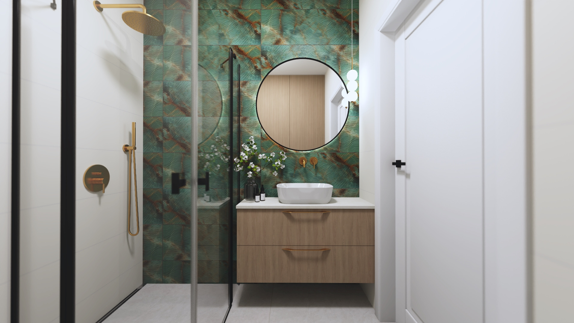 Nowoczesna łazienka z zielonymi płytkami o wzorzystej fakturze, okrągłym lustrem z podświetleniem LED, umywalką nablatową i złotą armaturą, widok z perspektywy kabiny prysznicowej.