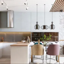 Nowoczesna kuchnia z wyspą, oświetleniem punktowym i trzema wiszącymi lampami nad stołem jadalnym, marmurowa ściana z telewizorem w tle.