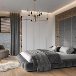 Nowoczesna sypialnia z ł&oacute;żkiem w odcieniach szarości, ozdobnym zagł&oacute;wkiem z drewna i tapicerowanymi panelami, okrągłym fotelem, dywanem imitującym sk&oacute;rę owczą oraz widokiem na g&oacute;ry za oknem.