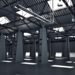 Radiator - Wnętrze hali przemysłowej z metalową konstrukcją dachu, oświetleniem i betonowymi kolumnami, światło słoneczne wpada przez okna dachowe.