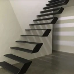 Nowoczesne, minimalistyczne schody wspornikowe z metalu, z geometrycznym kształtem stopni, zamontowane przy jasnej ścianie. Stopnie w kolorze grafitowym, tworzące efekt lewitacji. Widoczny betonowy...